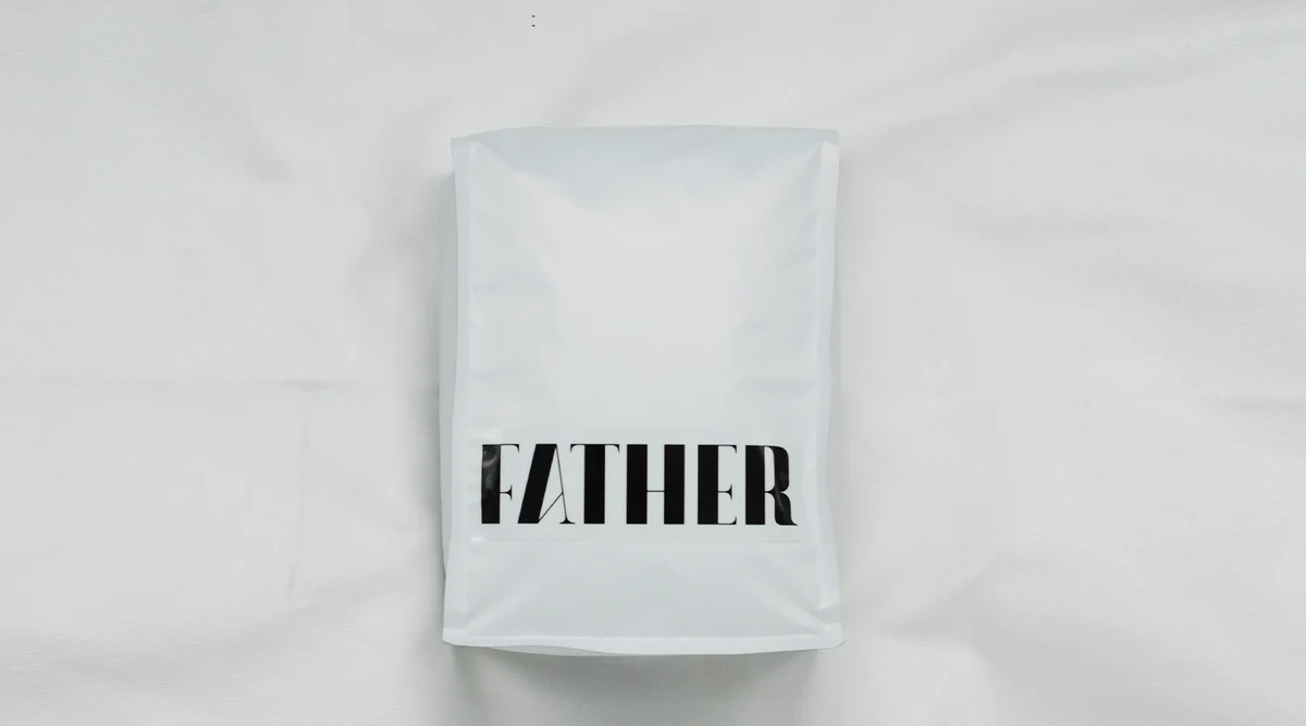 1kg bag of FATHER coffee with 'FATHER' printed on it against a white background
